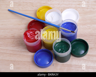Set of five color art paint tubes with paintbrush on wooden table Stock Photo