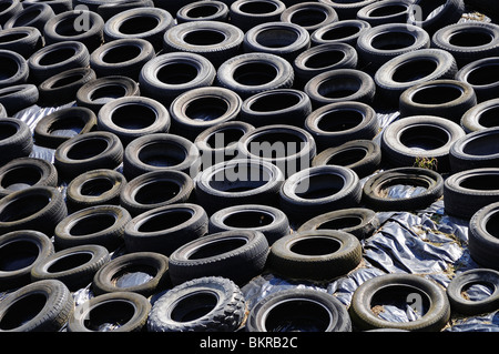 old tyres used on a farm to help protect the winter animal feed from the weather, lancashire, uk Stock Photo