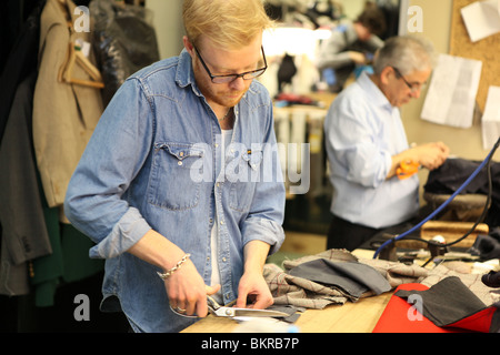 Tailors in the workshop of Henry Poole, in Savile Row London. Stock Photo