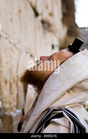 Praying by the wailing wall in the old city of Jerusalem. Stock Photo