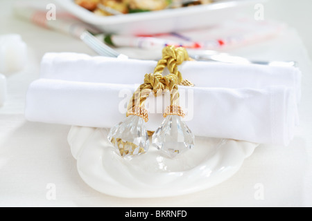 Luxury napkins with napkin ring on the white tablet Stock Photo