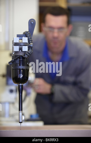 worker using a multisensor touch probe to inspect measurements Stock Photo
