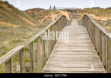 Wooden footbridge in sand dunes. Stock Photo