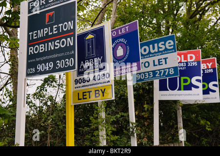 Row of 'For Sale' and 'To Let' estate agent's signs Stock Photo