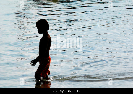 young boy playing in the sea , chao leh, sea gypsy village , rawai beach , phuket island ,thailand Stock Photo