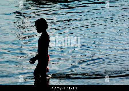 young boy playing in the sea , chao leh, sea gypsy village , rawai beach , phuket island ,thailand Stock Photo