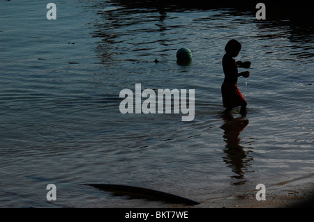 sea gypsy boys playing in the sea,chao leh, sea gypsy village , rawai beach , phuket island ,thailand Stock Photo