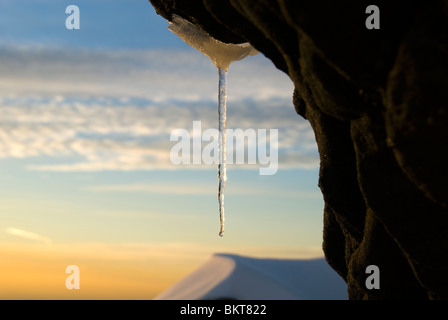 Icicle on a rock on the Kinder Scout plateau in winter, near Hayfield, Peak District, Derbyshire, England, UK Stock Photo