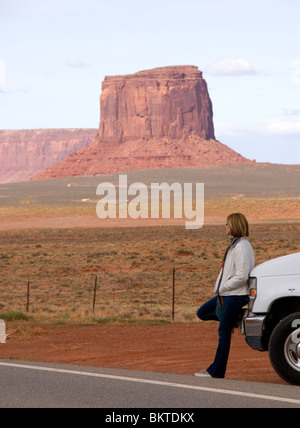 Female tourist leaning on Cruise America RV campervan Monument Valley Highway 163 Arizona Utah border USA Kim Paumier MR Stock Photo