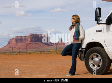 Female tourist leaning on Cruise America RV campervan Monument Valley Highway 163 Arizona Utah border USA Kim Paumier MR Stock Photo