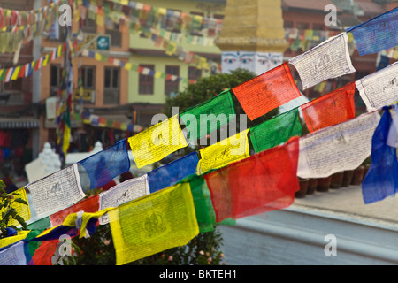 Prayer flags fly at the Buddhist shrine BODHANATH STUPA, one of the largest in the world - KATHAMANDU, NEPAL Stock Photo