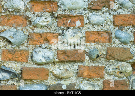 Flint stones and bricks set in lime mortar. Wall, Hickling, Norfolk, England. UK. Stock Photo