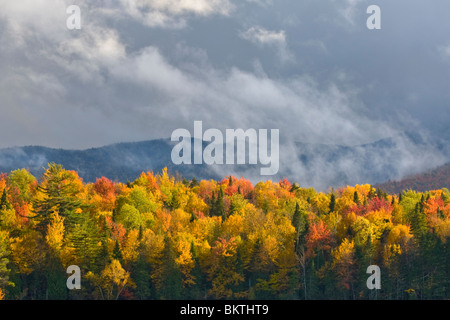 Stomy sky over fall colors over Franklin Falls Pond in the Adirondack Mountains of New York State Stock Photo
