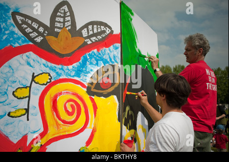Celebration of World 'Fair Trade' Day, with Men Painting Wall on Lawn of La Villette Park, to Encourage Purchase Fair Trade, Street art Stock Photo