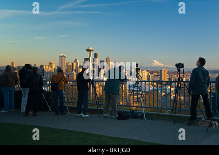 People taking photos of The Space Needle, city skyline and Mount Rainier from Kerry Park on Queen Anne Hill; Seattle, Washington Stock Photo