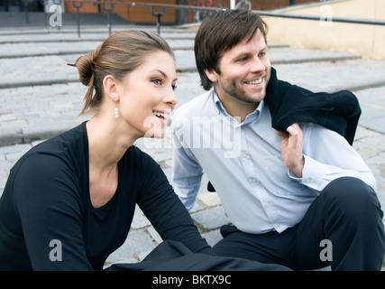 Man and woman sitting on staris Stock Photo