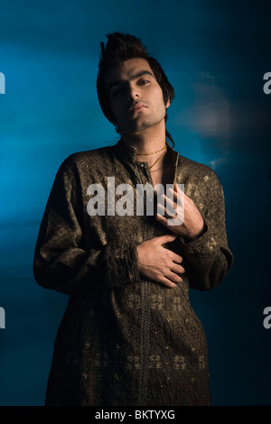 Young man standing against colored background, portrait Stock Photo