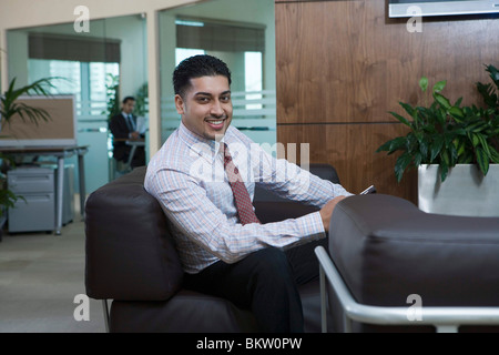 Businessman sitting in office, portrait Stock Photo