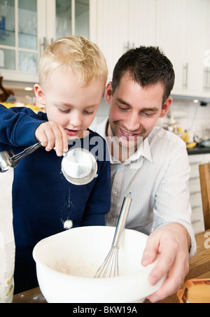 Father and child having fun in the kitchen Stock Photo