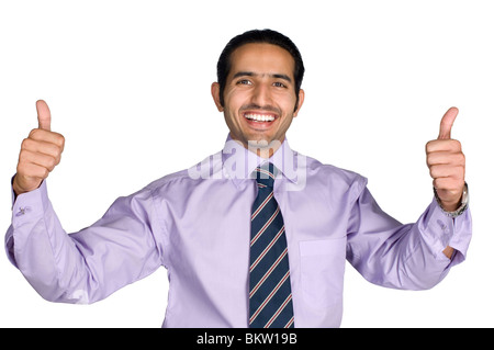 Businessman showing thumbs up, smiling, portrait Stock Photo