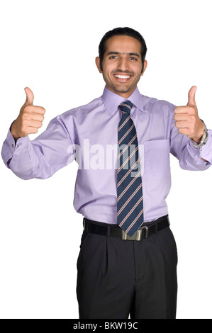 Businessman showing thumbs up, smiling, portrait Stock Photo