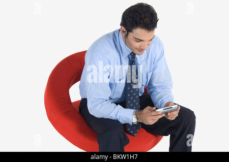 Young businessman using PDA Stock Photo