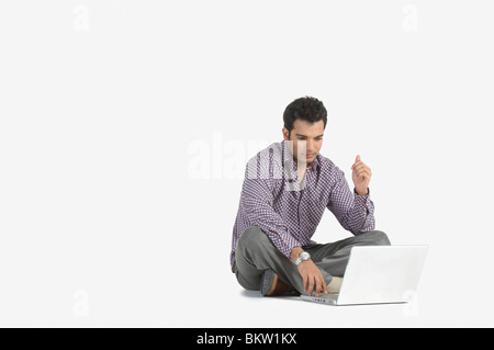 Young man using laptop Stock Photo