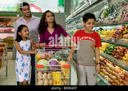 Family at supermarket, smiling Stock Photo