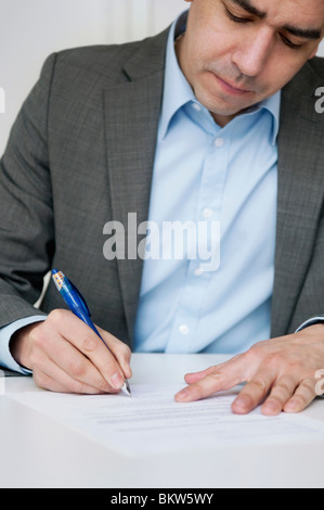 Man signing paper Stock Photo