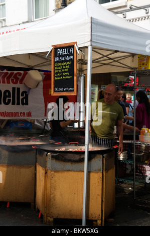 Paella food stall, Portobello Road Market Notting Hill West London England UK Stock Photo