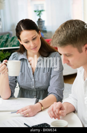 Couple drinking coffee and counting Stock Photo