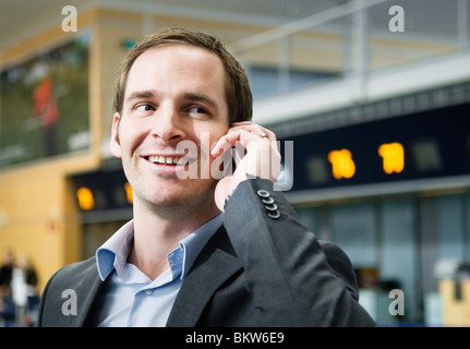 Man talking in phone at airport Stock Photo