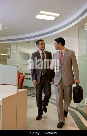 Two businessmen walking in the office corridor Stock Photo