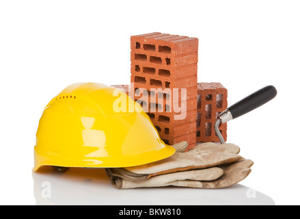 hardhat, protective gloves, trowel and bricks on white background Stock Photo