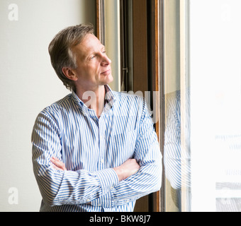 businessman looking out through the window Stock Photo