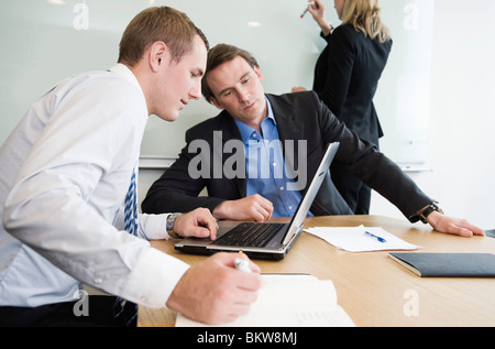 Two men and a woman in the conference room Stock Photo