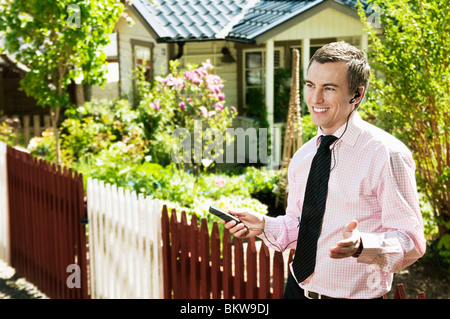 Man leaning against fence Stock Photo