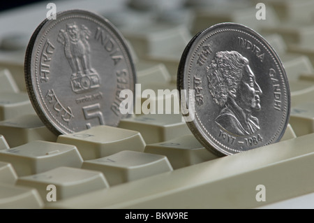 Two indian rupee coin on top of a computer keyboard