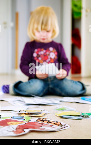 Blonde girl sitting on floor with penny board Stock Photo - Alamy