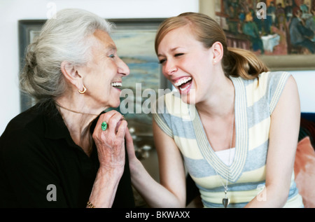 A young and an elderly woman laughing Stock Photo