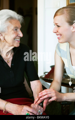 Woman taking care of elderly lady Stock Photo