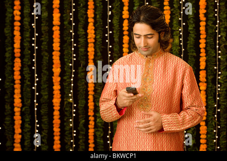 Young Indian man using her cellphone Stock Photo