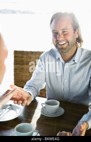 Closeup on men holding hands Stock Photo