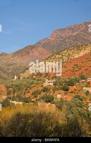 Red walled Berber Village in the Atlas Mountain foothills near to Setti Fatma with a mosque minaret