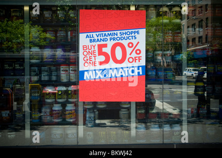 A sale sign posted on the window of a Vitamin Shoppe store in New York Stock Photo
