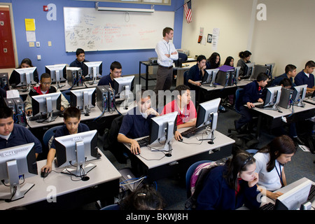 Teacher monitors high school students in computer lab at charter school Peak Preparatory Academy in Dallas, Texas, USA. ©Bob Daemmrich Stock Photo