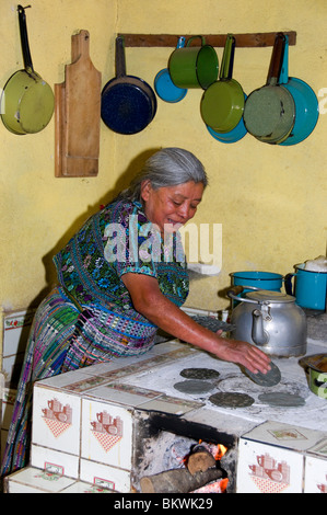 Mayan Indigenous woman making tortillas oven Guatemala Stock Photo