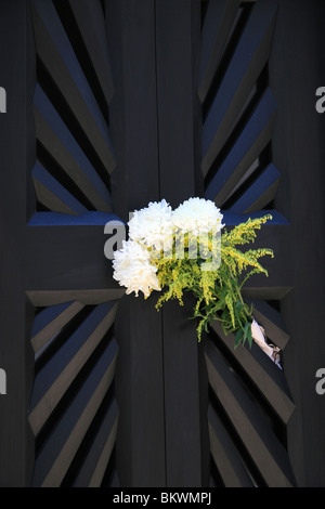 White carnations on a door in the Recoleta cemetery, Buenos Aires, Argentina Stock Photo