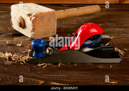 planer carpenter hand tool wood shaving over wooden board Stock Photo