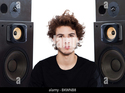 studio portrait of a one caucasian young man listening to music lover with speakerphones isolated on white background Stock Photo